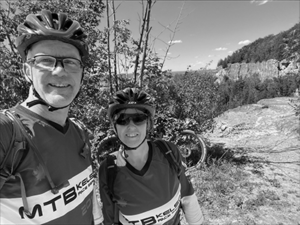 Nial and ines Fisher posing on top of a mountain bike trail