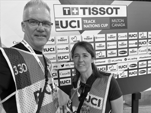 Nial and Ines Fisher posing infront of UCI track nations cup backdrop