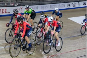 2 milton revolution cycling club riders race on the insde of the velodrome