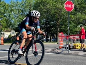 Anna banking around a corner in a road cycling race