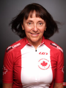 Anna headshot, black background wearing canadian track champions jersey