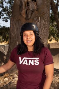 Woman smiling in her bmx helmet and vans t-shirt