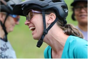 woman cyclist wearing her bike helmet laughing