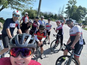 Newmarket Eagles group ride group pgoro taken beside the waterfront on their bicycles smiling