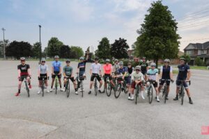 St Catharines Cycling Club group photo in full cycling kit, on their bicycles smiling