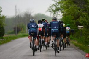 Group ride peloton from behind on a paved road through rural Ontario